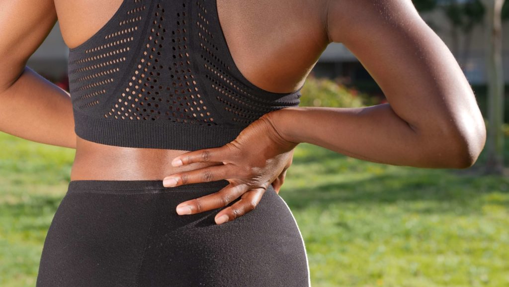 A lady experiencing chronic lower back pain